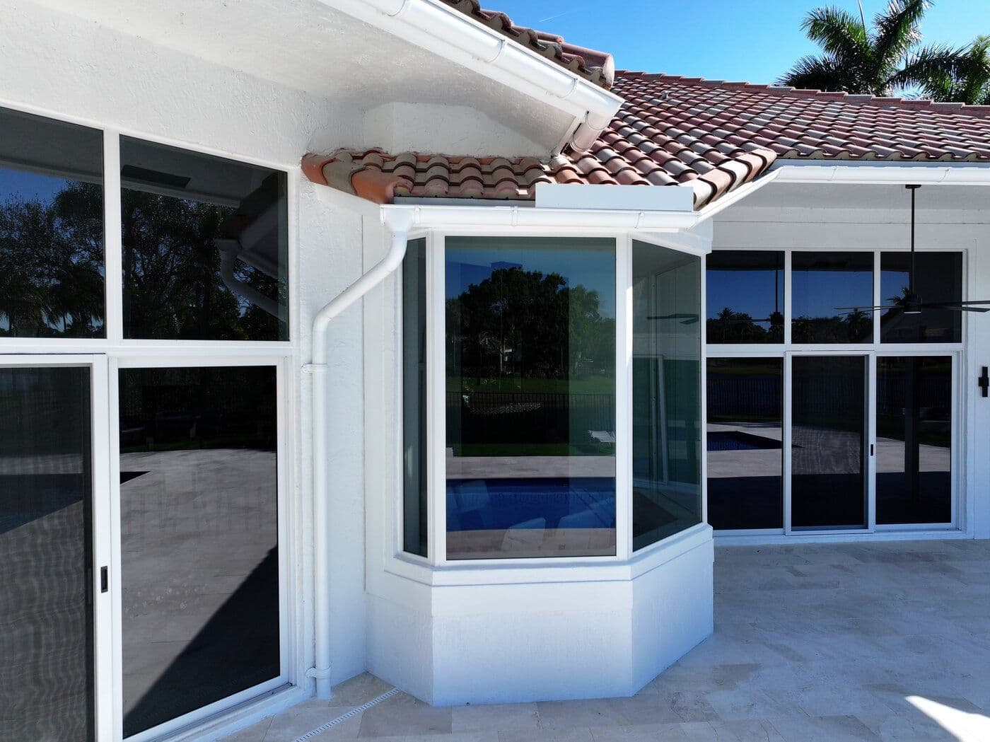 Spanish-tile-roofed home with new impact windows installed by Premier Impact Windows & Roofing